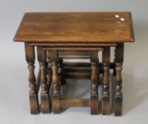 A nest of three oak tables. 61 cm wide.