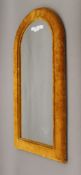 A late 19th/early 20th century arched velvet covered wall glass. 77 cm high.