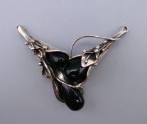 A silver dress pendant. 7 cm wide.