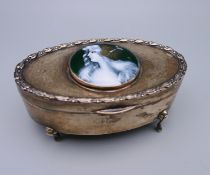 A silver oval enamel top jewellery casket. 11 cm wide.