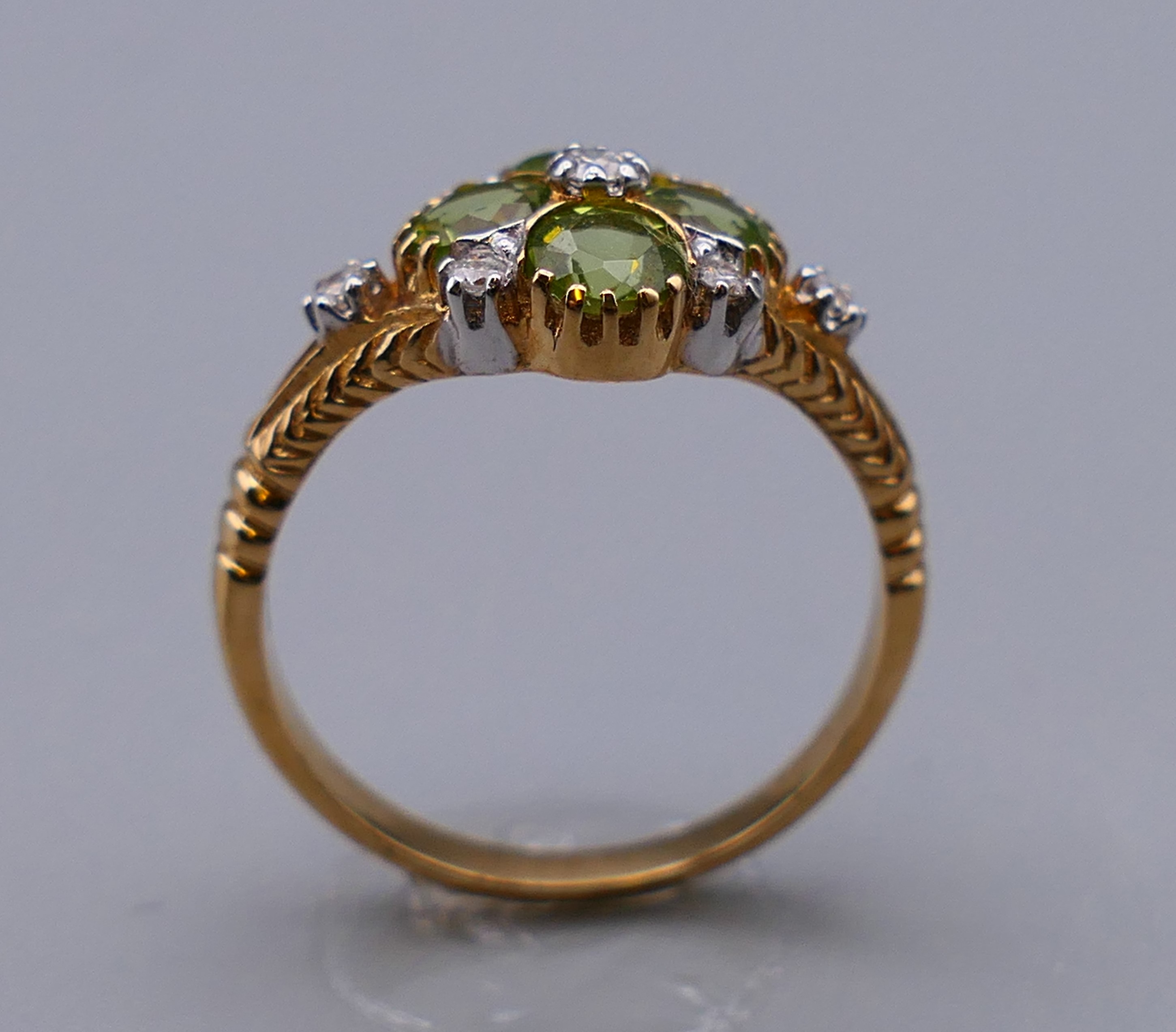 A 9 ct gold Victorian style diamond and peridot ring, engraved design to the sides. Ring size M/N. - Image 2 of 7