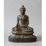 An antique bronze model of Buddha mounted on a wooden base. 21 cm high.