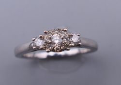 A silver diamond set cluster ring. Ring size L/M.