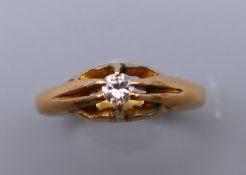 A gentleman's 18 ct gold and diamond gypsy set ring. Ring size T. 4.7 grammes total weight.