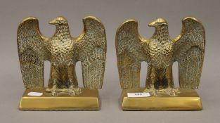 A pair of brass eagle form door stops. Each 15 cm high.