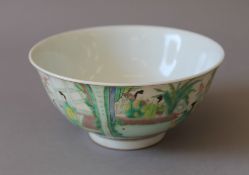 A Chinese green and blue porcelain figural bowl. 15.5 cm diameter.