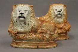 Two Victorian Staffordshire pottery lions. The largest 24 cm high.