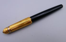 A Cartier ball point pen. 14 cm long.