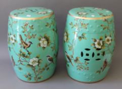 A pair of green porcelain barrel seats. 45 cm high.