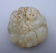 A jade roundel formed as two boys. 5 cm wide.