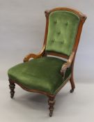 A Victorian upholstered walnut framed nursing chair. 56 cm wide.