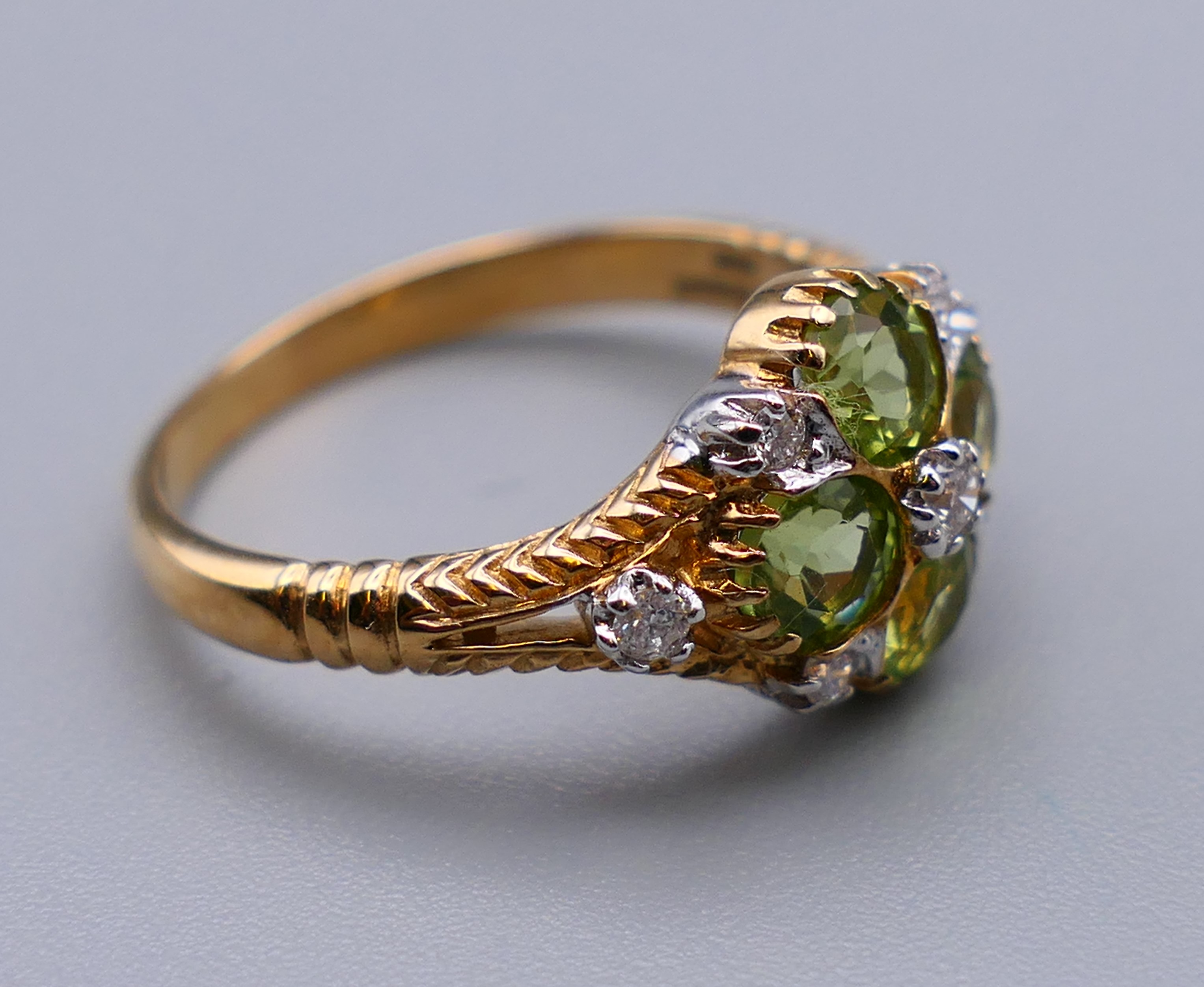 A 9 ct gold Victorian style diamond and peridot ring, engraved design to the sides. Ring size M/N. - Image 5 of 7