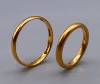 Two 22 ct gold wedding bands, ring sizes M/N and V/W respectively. 8.8 grammes.