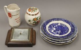 A box of various ceramics and a barometer.