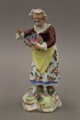 A Dresden porcelain figurine modelled as a flower girl. 14.5 cm high.