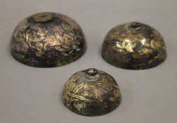 Three ornate antique bells. The largest 9 cm diameter.