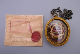 A 19th century reliquary pendant and a wax seal panel. The former 8 cm high.