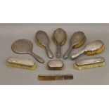 A quantity of various silver backed dressing table sets.