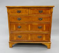 A modern yew wood veneered chest of drawers. 75 cm wide.