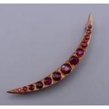 A 9 ct rose gold crescent shaped brooch set with diamonds and almadine garnets with Chester