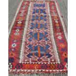 A large Kilim rug. 388 x 149 cm.