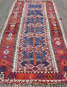 A large Kilim rug. 388 x 149 cm.