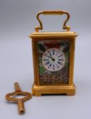 A miniature carriage clock with porcelain panels. 7.5 cm high.