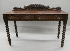 A Victorian carved oak two drawer side table. 147 cm wide.