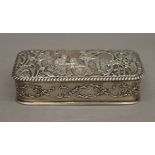 An embossed silver box. 13 cm wide.