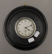 A vintage Smith's car clock housed in an ebonised case. 22 cm diameter overall.