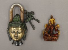 A Buddha padlock and a model of Buddha. The former 15 cm high.