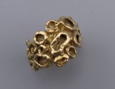 An 18 ct gold ring in an abstract design. Ring size F/G. 10.1 grammes.