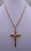 A 9 ct gold crucifix on a 9 ct gold chain. The crucifix 5 cm high. 8 grammes.