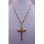 A 9 ct gold crucifix on a 9 ct gold chain. The crucifix 5 cm high. 8 grammes.