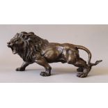 A bronze model of a lion. 33 cm long.