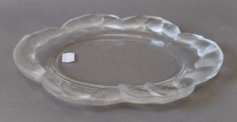 A Lalique glass fish plate, signed Lalique France. 27 cm wide.