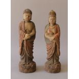 Two Eastern carved wooden figures. The largest 29 cm high.
