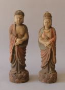 Two Eastern carved wooden figures. The largest 29 cm high.