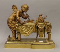 A bronze model of a cherub. 33.5 cm wide.