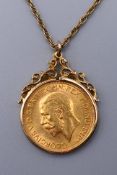 A 1930 sovereign on a 9 ct gold chain and mount. 13.5 grammes total weight.