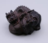 A Japanese netsuke formed as a dragon and dog. 5.5 cm wide.