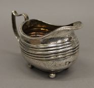 A Georgian silver cream jug. 14 cm long.