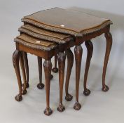 A nest of three walnut tables. 57 cm wide.