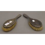 Two silver backed brushes.