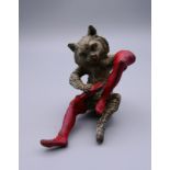 A cold painted model of a cat polishing his boots. 7 cm high.