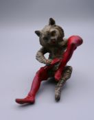 A cold painted model of a cat polishing his boots. 7 cm high.