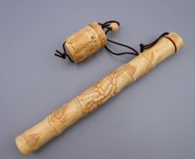 A Japanese bone scroll holder. 22.5 cm long.