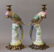 A pair of gilt metal mounted porcelain candlestick formed as parrots. 40.5 cm high.