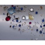 A quantity of assorted gemstones, including diamonds, sapphires, etc.