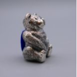 A silver teddy bear pin cushion. 3 cm high.